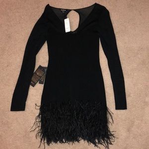 NEVER WORN Bebe dress in black with bottom feather